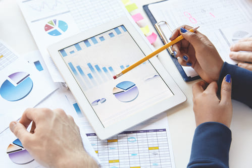businesspeople-sitting-table-with-touch-pad-notes-developing-business-strategy-making-changes-financial-report (1) (1)